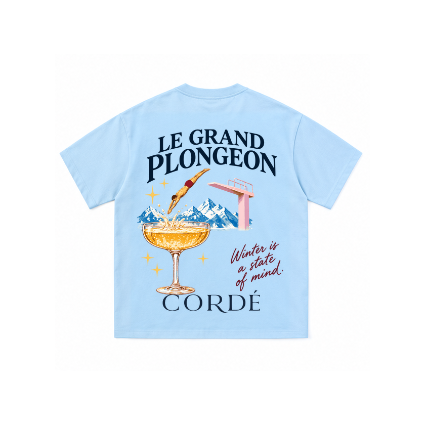 CORDÉ Powder Blue T-shirt, back: diver, champagne coupe and snowy mountains.