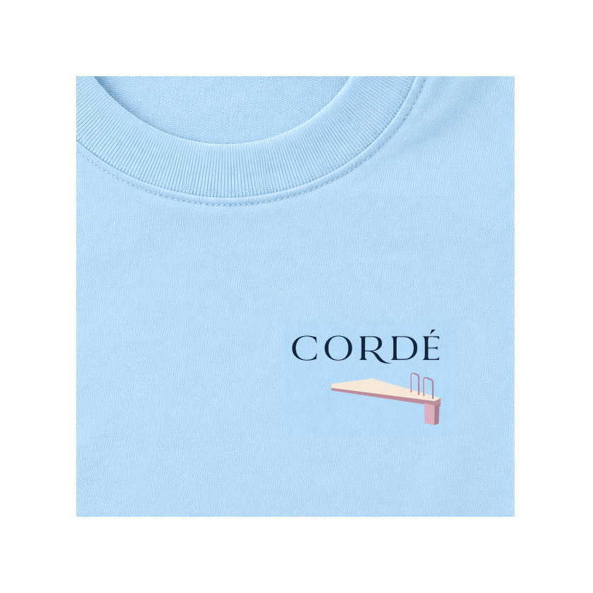 CORDÉ Powder Blue T-shirt, front detail: CORDÉ logo and diving board.