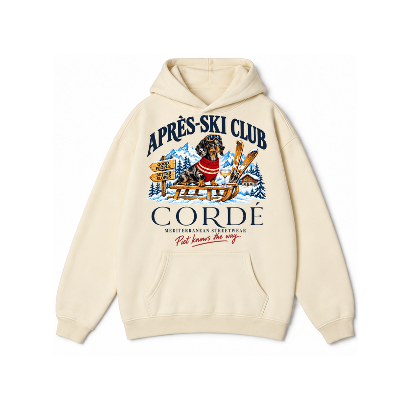 CORDÉ Cream hoodie, front: Piet on a sled with skis and an Alpine chalet.