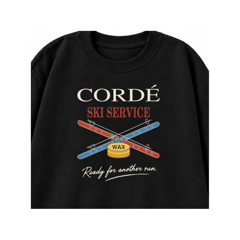 CORDÉ Black longsleeve, front detail: CORDÉ Ski Service lettering, crossed skis and wax tin.