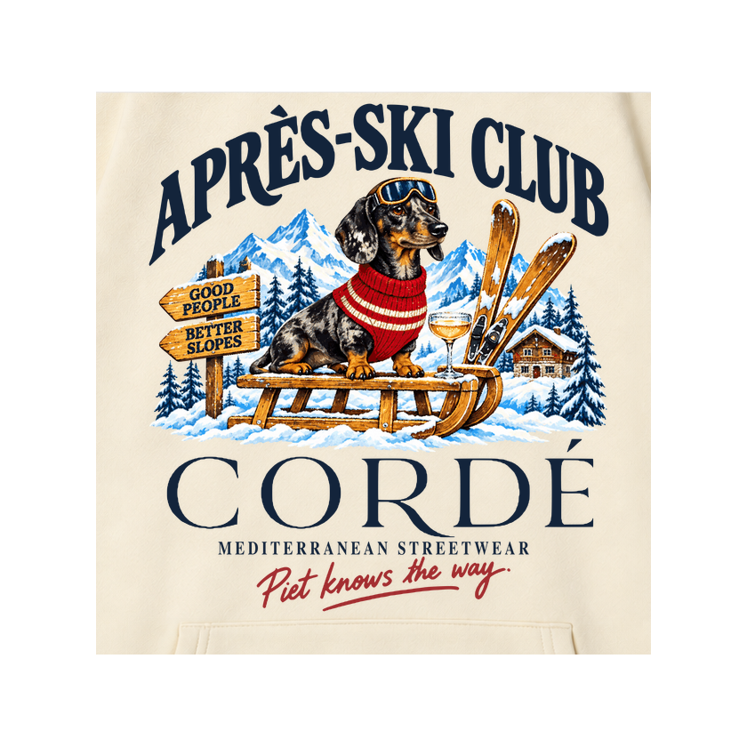 CORDÉ Cream hoodie, front detail: Piet on a sled with skis and an Alpine chalet.