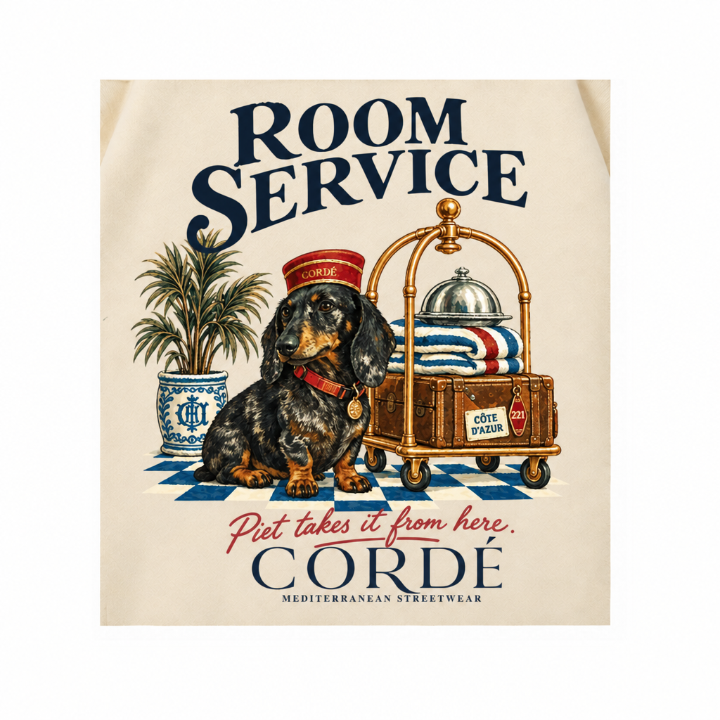 CORDÉ Cream hoodie, back detail: Piet in a bellboy hat beside a luggage trolley.
